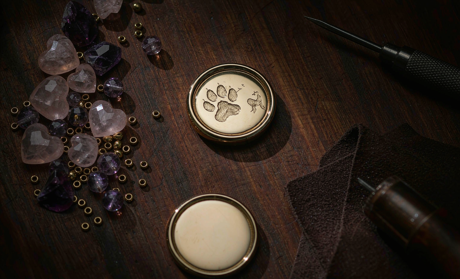 Hand-engraved gold tag and loose crystals in our studio